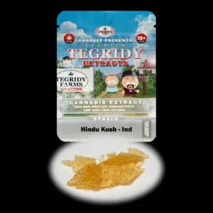 “Tegridy Extracts Hindu Kush shatter concentrate featuring translucent light golden shatter with a clear glass-like appearance and stable texture.”