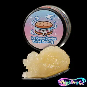 “Whip & Drip Co. Ice Cream Cookies cured resin concentrate with pale golden extract displayed beside ice cream and cookie-themed 1 gram product packaging on a black background.”