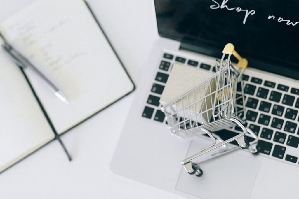 A miniature shopping cart on a laptop keyboard